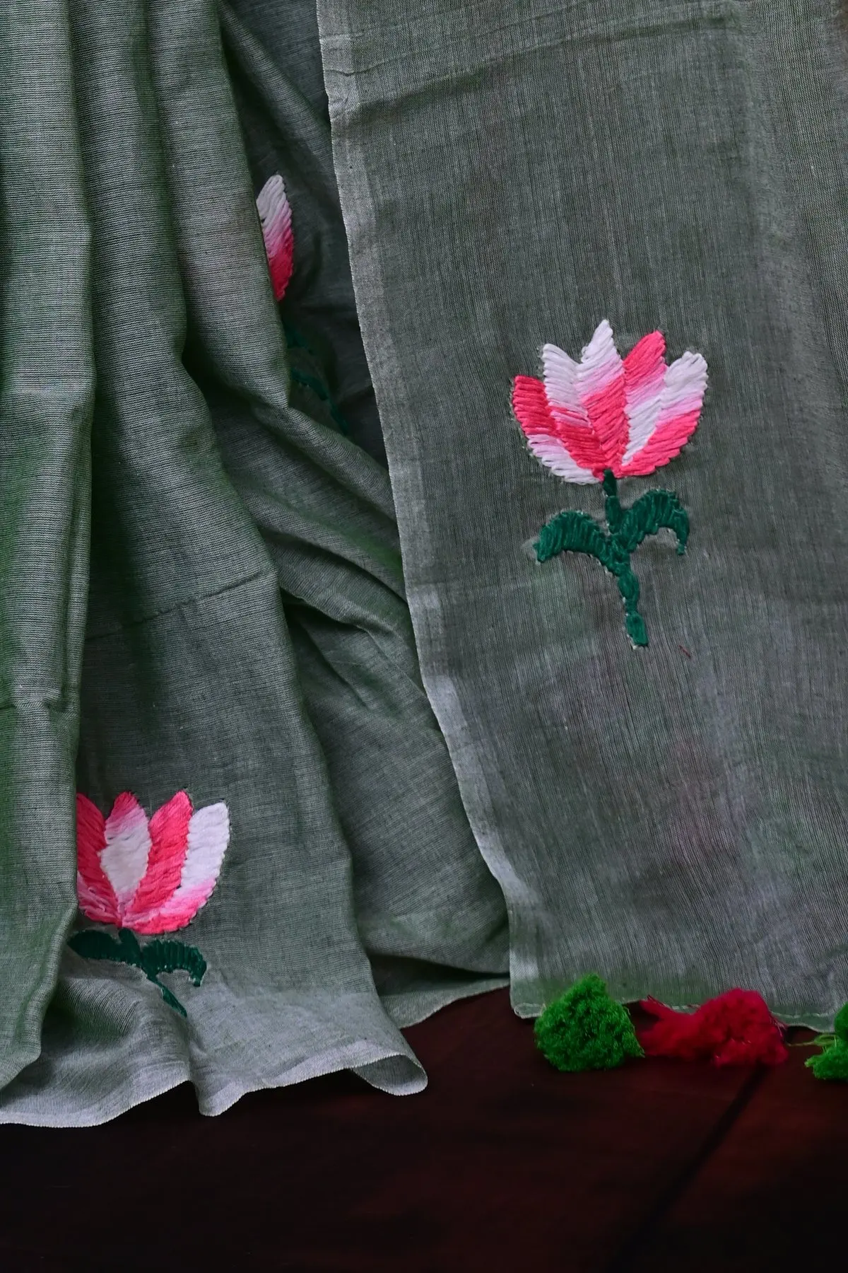 Sage green cotton saree with pink lotus embroidery, pallu