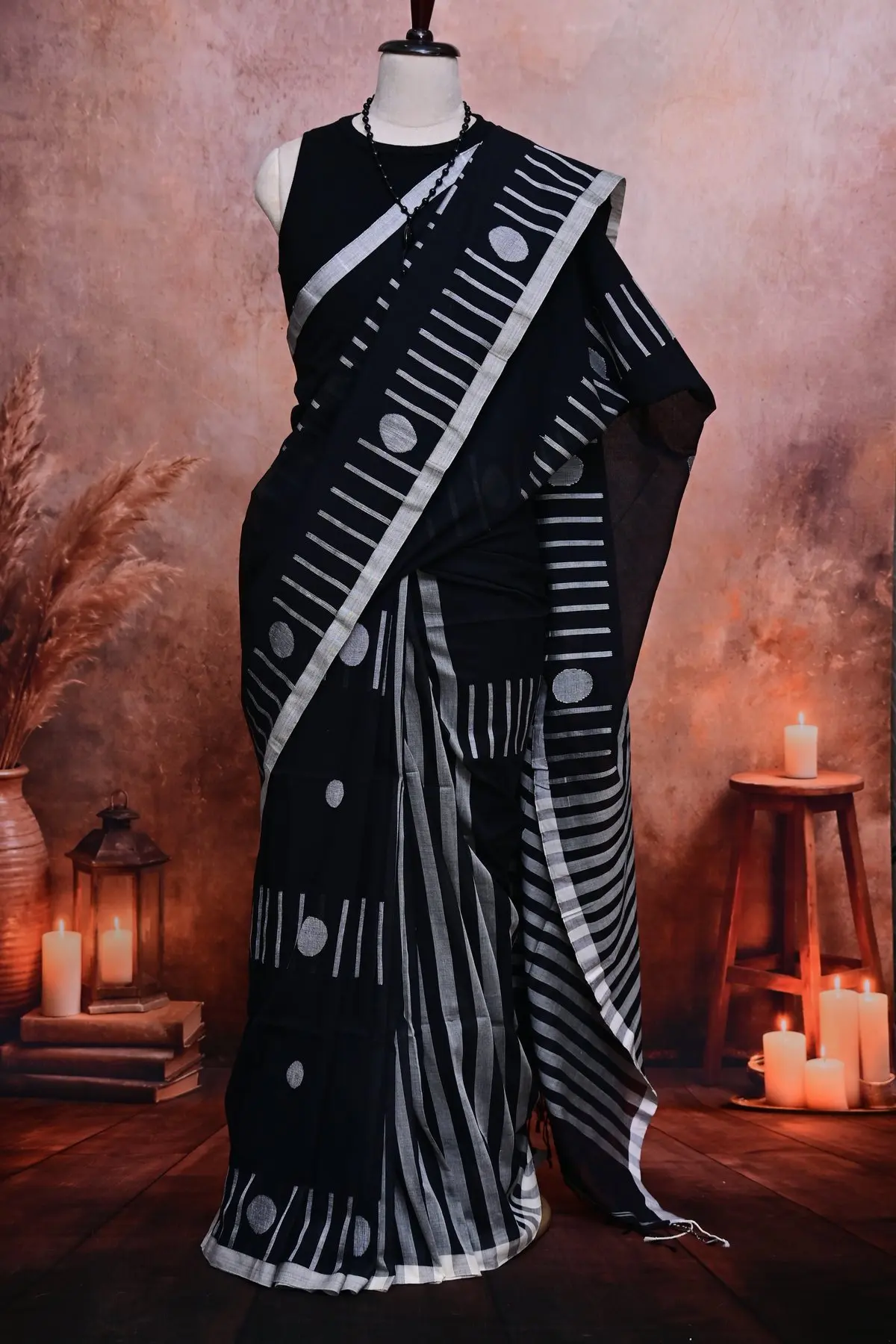 Black cotton saree with white circles and dashes and a plain white border.