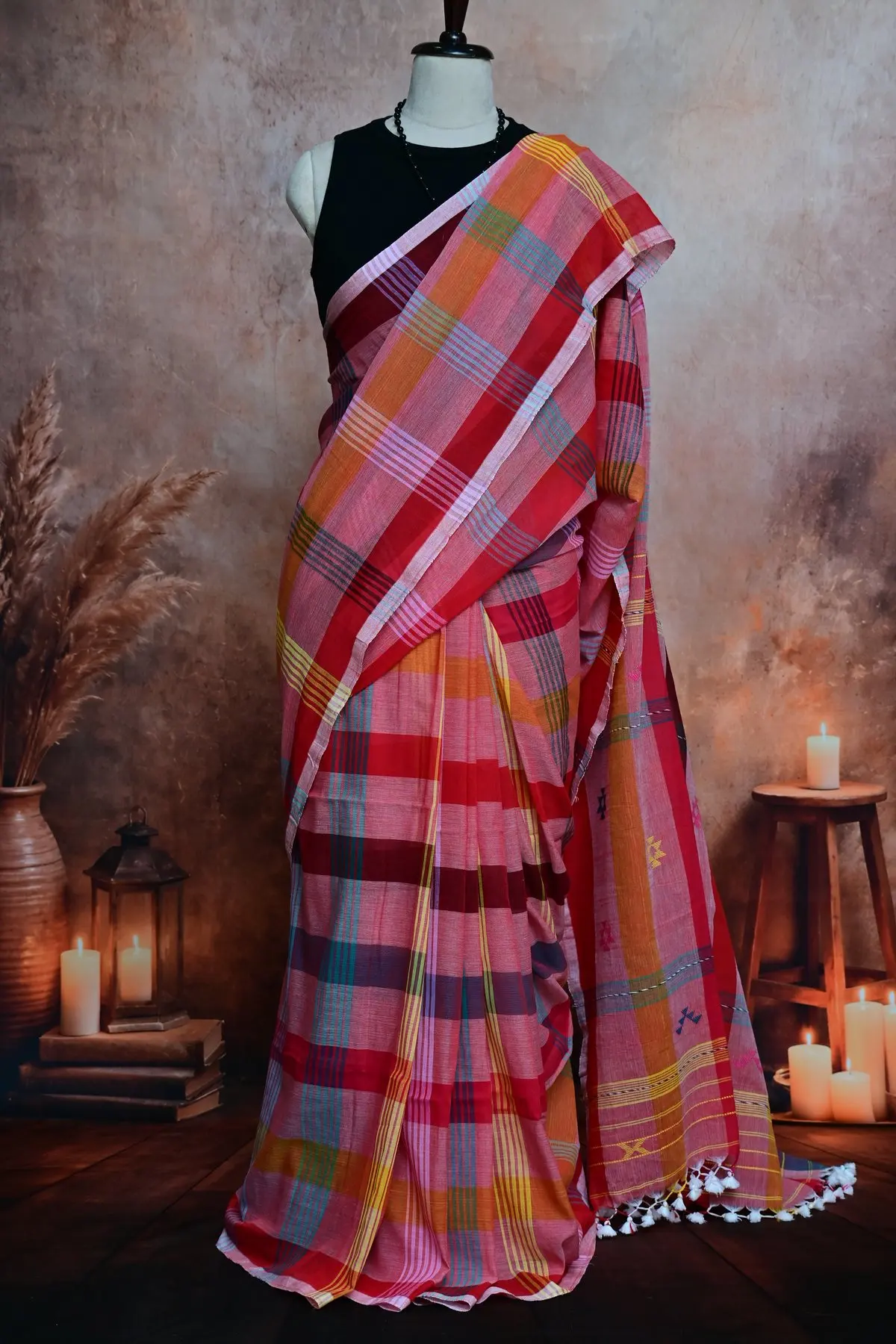 Pink and red plaid cotton pleats next to a pallu with small blue, yellow and pink geometric motifs.