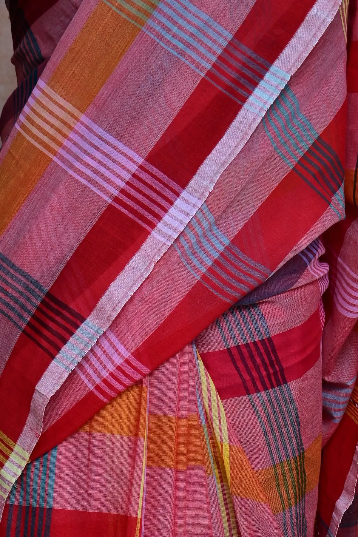 Pink plaid cotton saree with geometric motifs, close-up