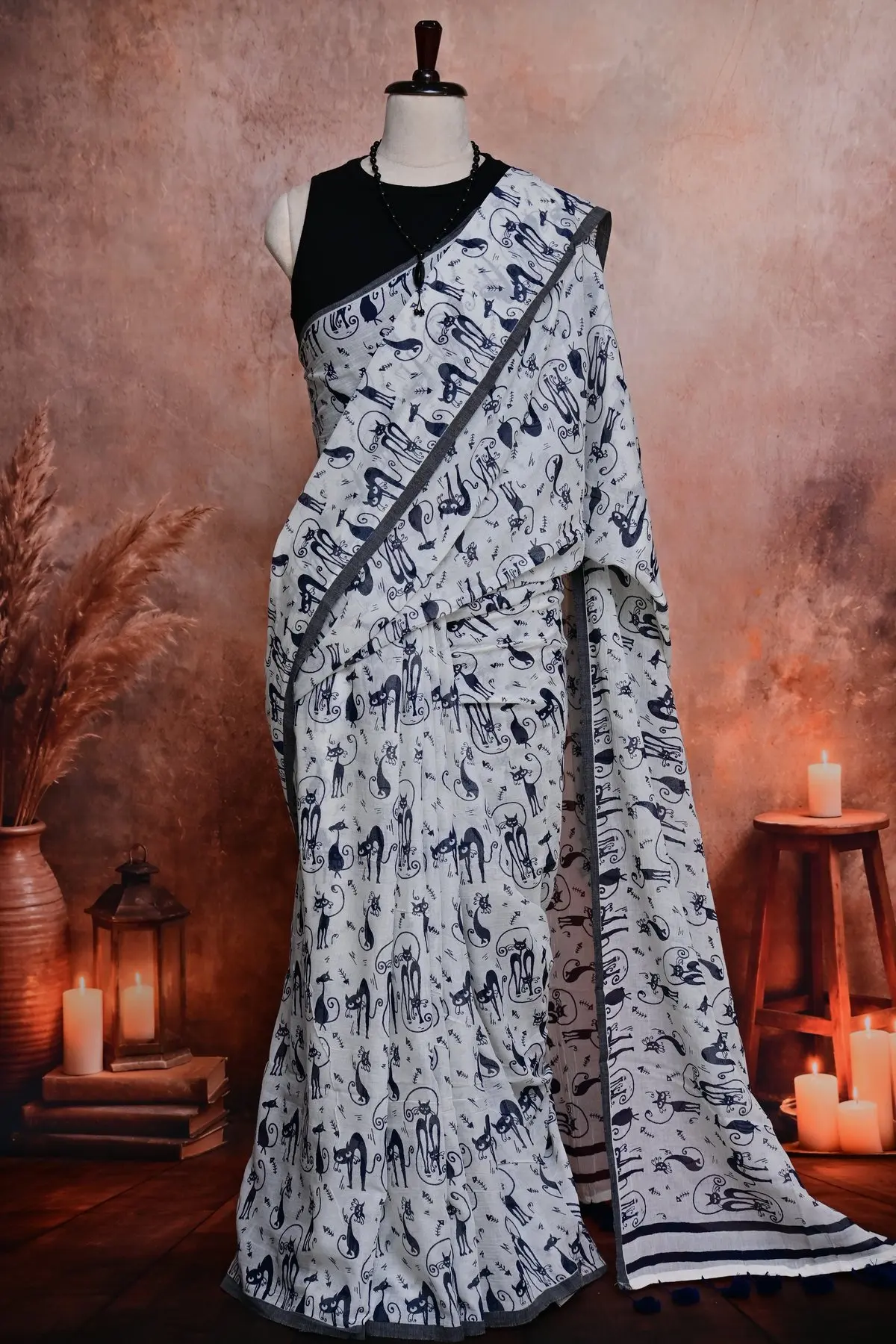 White cotton saree pleats printed with navy cats and fish bones.