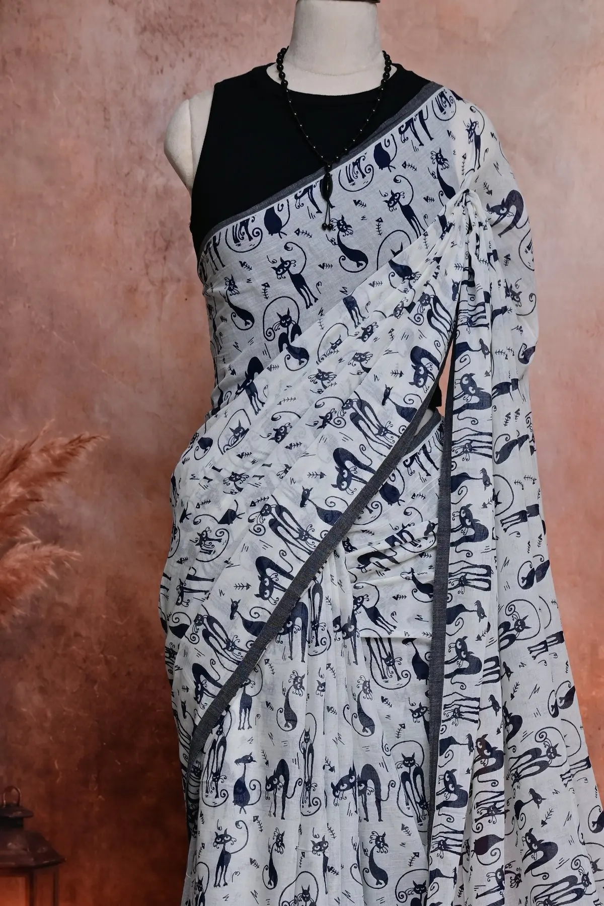 White cotton saree with navy cat print, 3/4 view