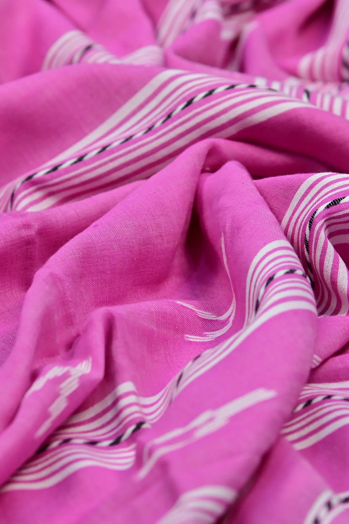 Pink cotton saree with white stripes and tassels, texture