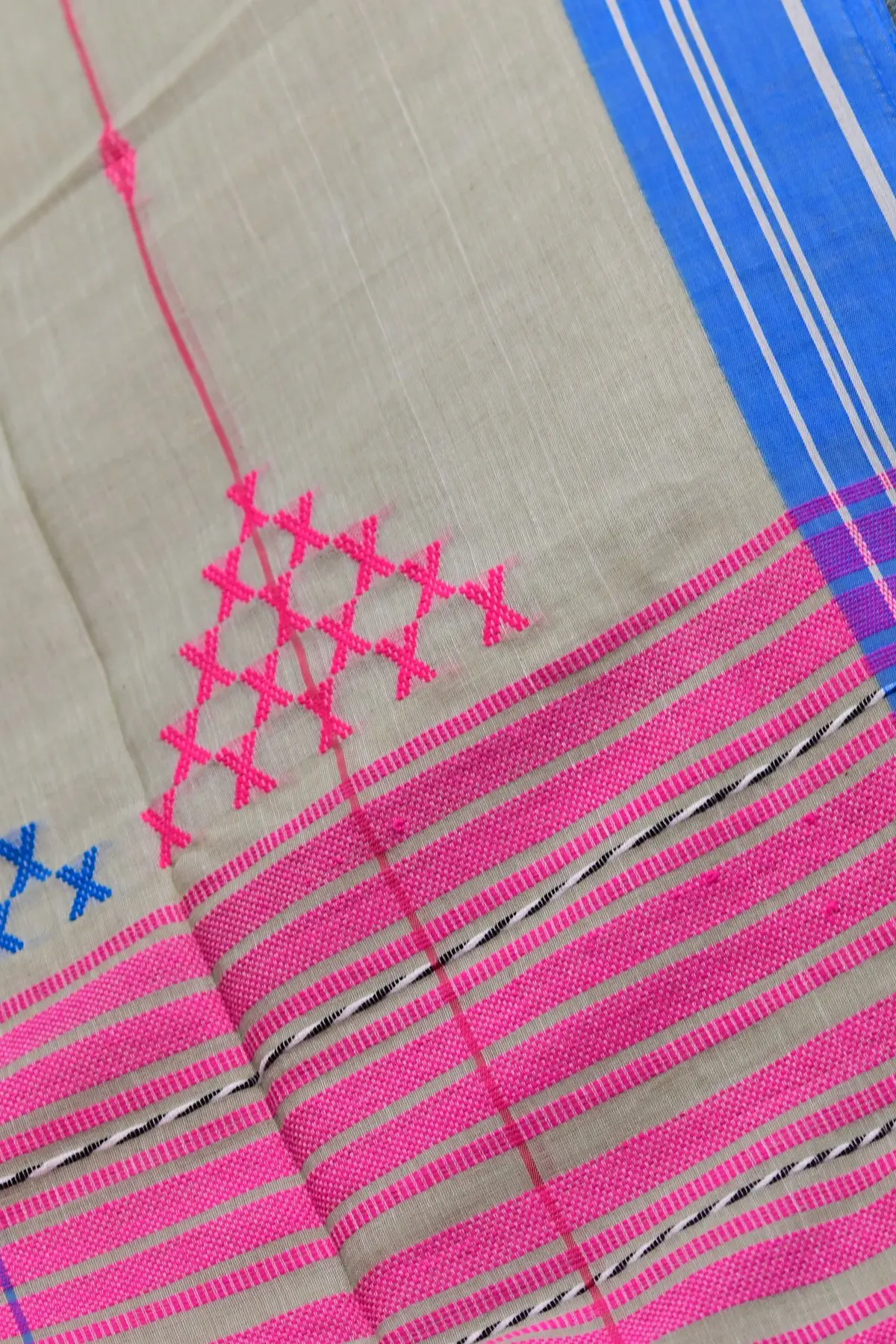 Grey and pink saree fabric gathered in folds, with pink stripes and small pink and blue cross motifs.