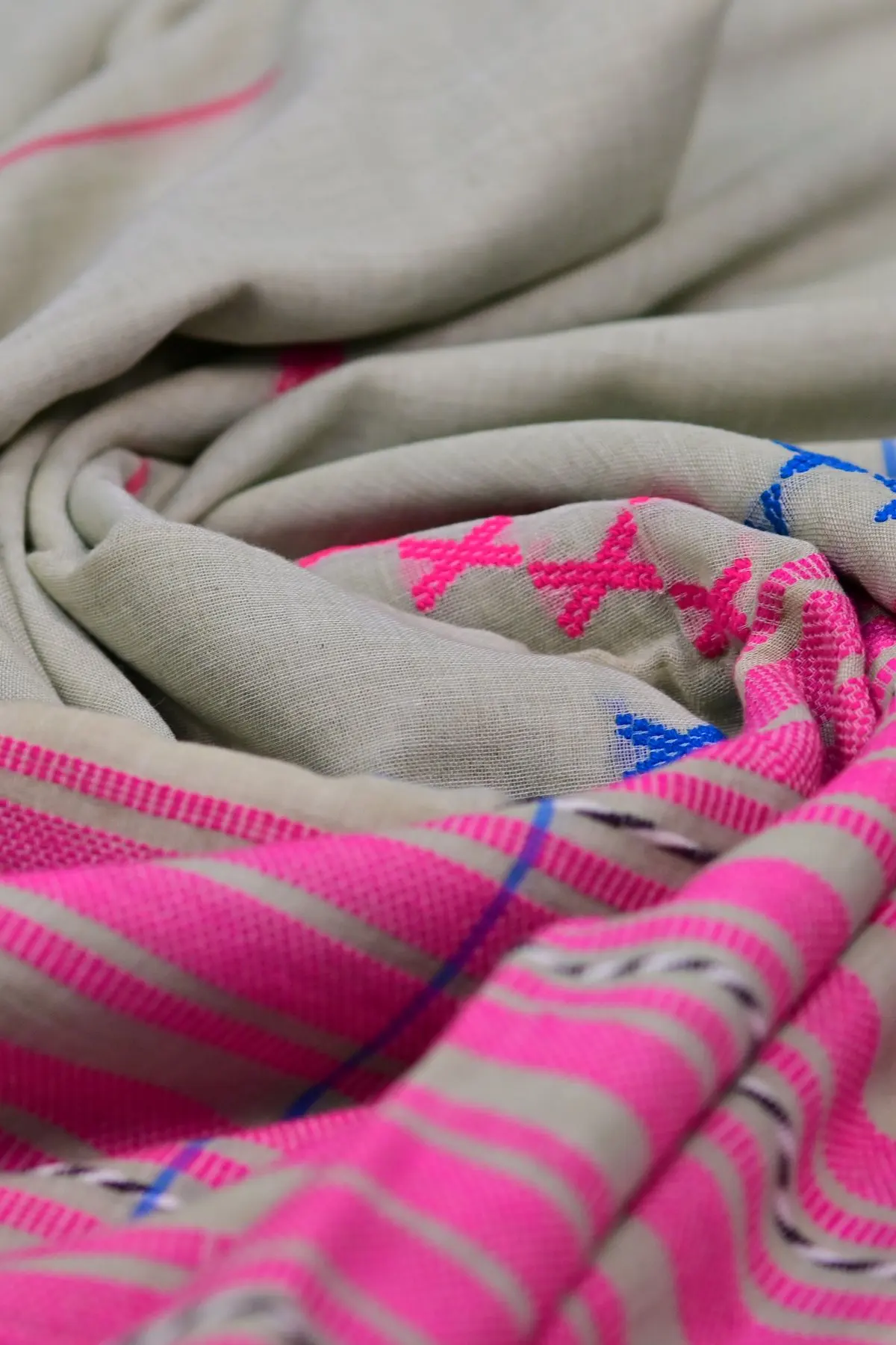 Grey cotton saree with pink stripes and cross motifs, texture