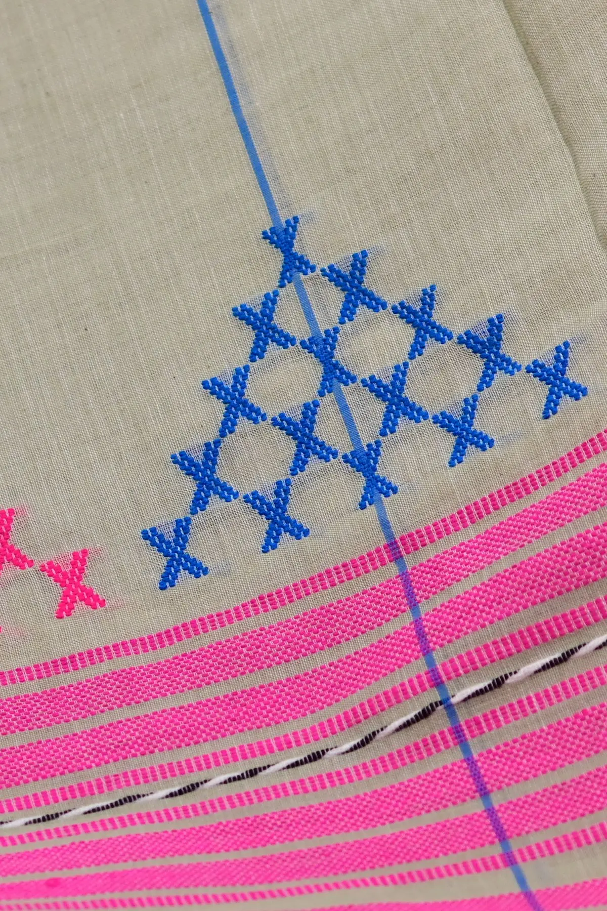 Grey cotton saree with pink stripes and cross motifs, close-up