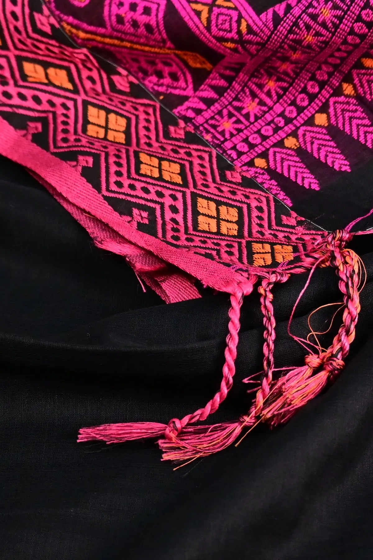 Black cotton saree with pink geometric pallu, tassels