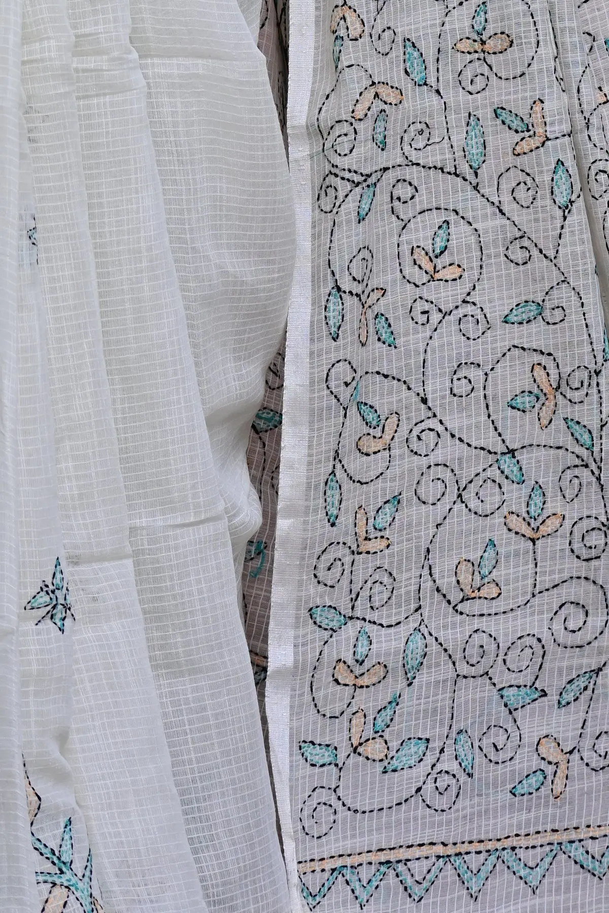Off-white cotton saree with teal embroidered vines, pallu