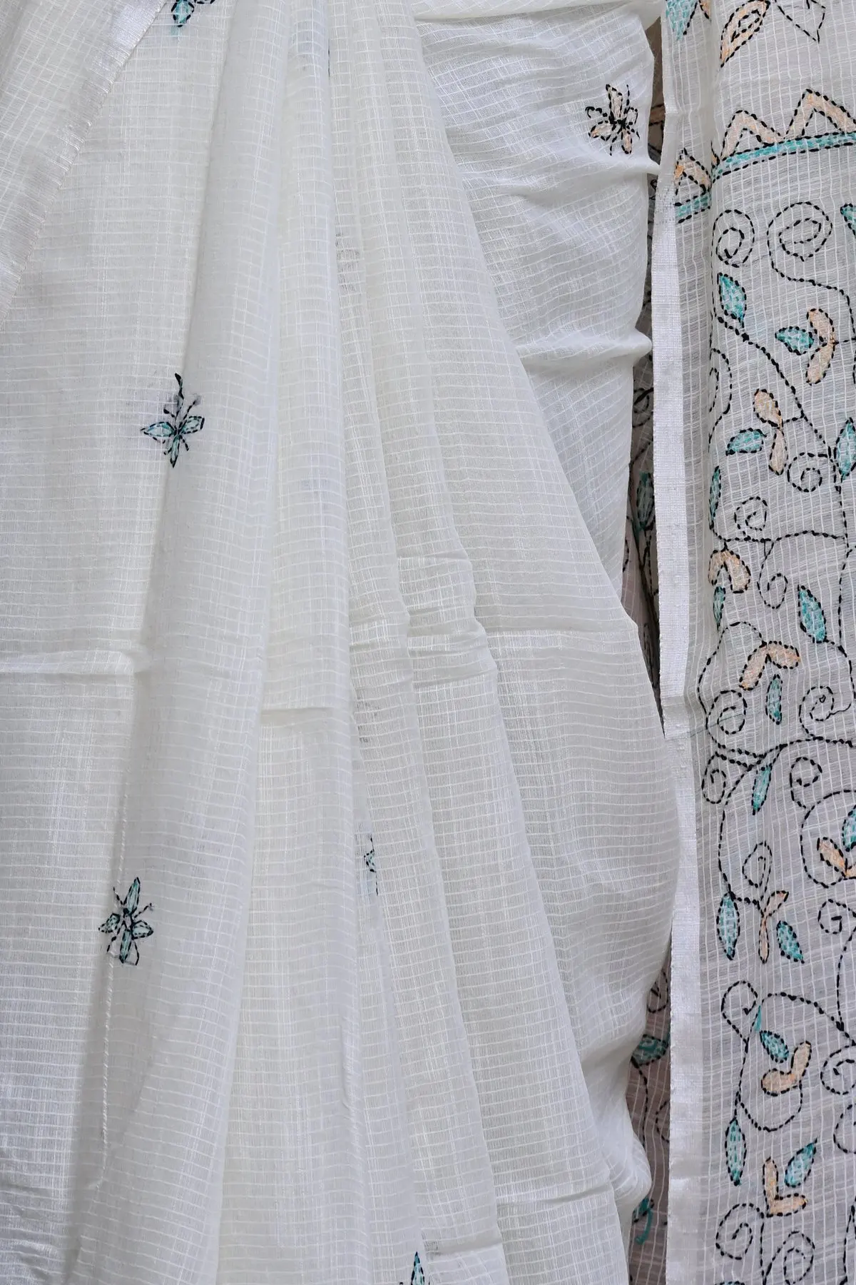 Off-white cotton saree with teal embroidered vines, overall view