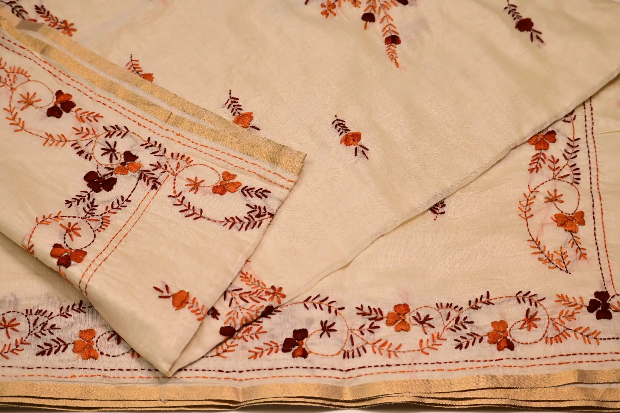 Cream saree with rust and maroon floral embroidery, overall view