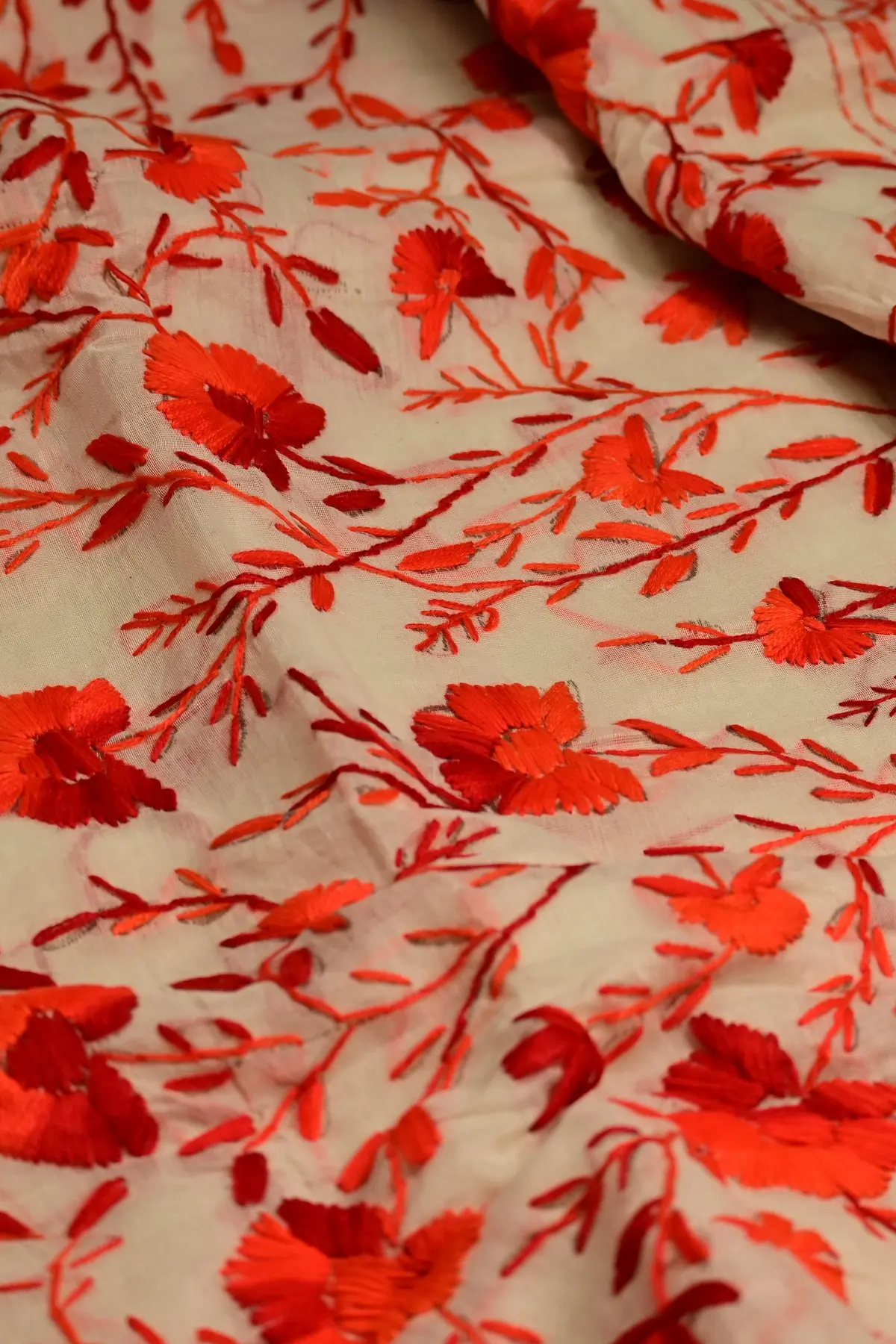 Ivory saree with red floral vine embroidery, texture