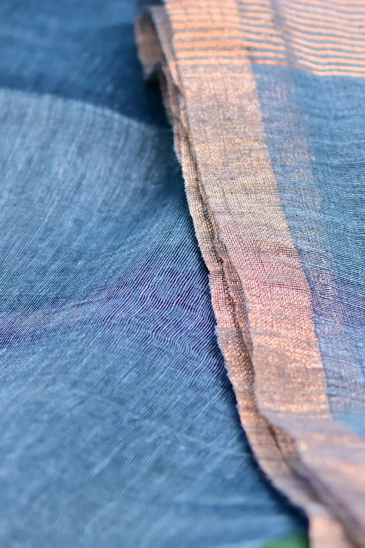 Blue linen saree with lotus motifs, border
