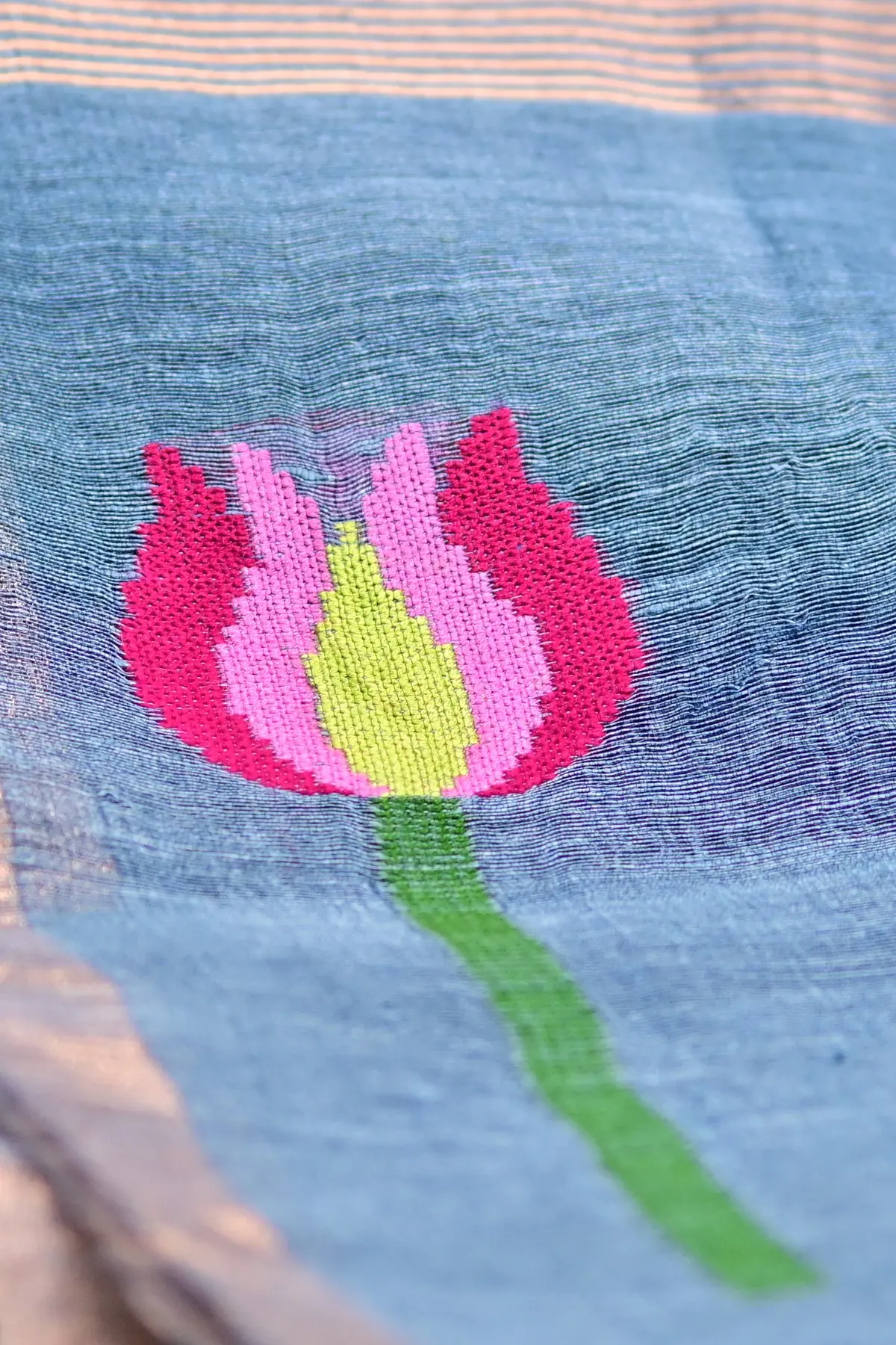 Blue linen saree with lotus motifs, close-up