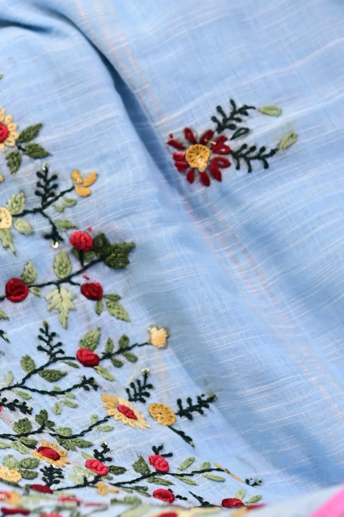 Pale blue linen saree with floral embroidery, close-up