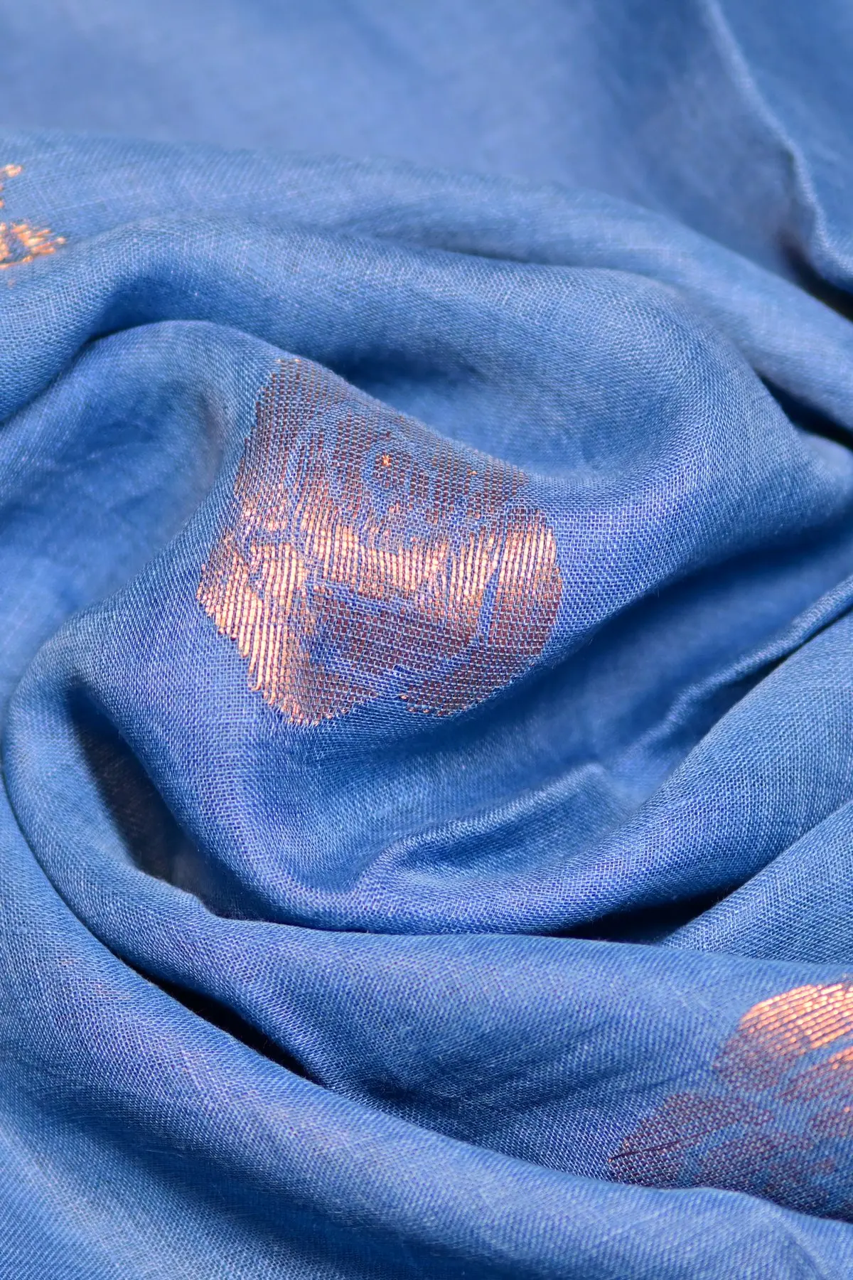 Blue linen saree with gold rose motifs, texture