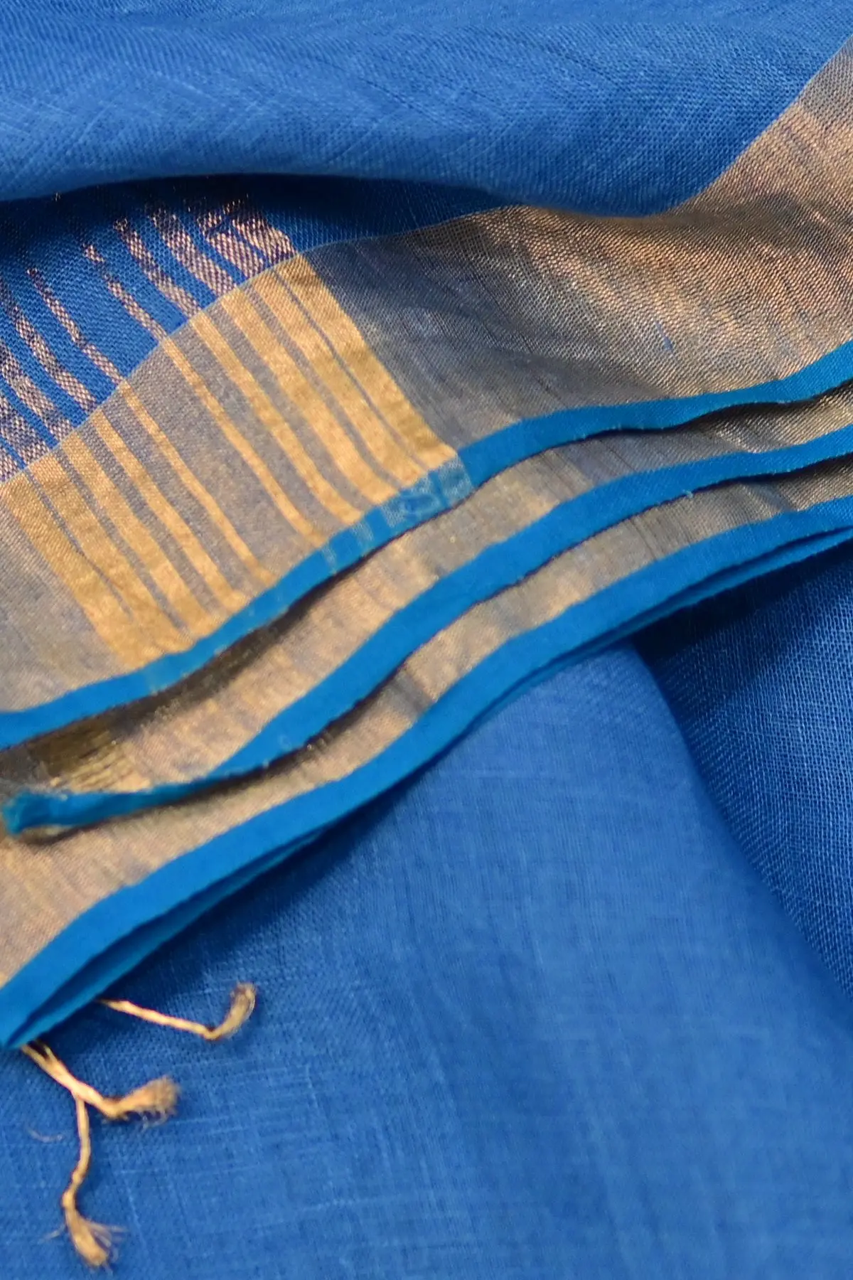 Blue linen saree with gold rose motifs, border